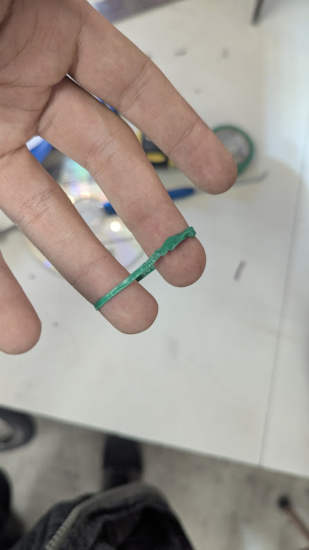 A rubber band made of electrical tape that looks like it's been sandwhiched between two gears while they were running.